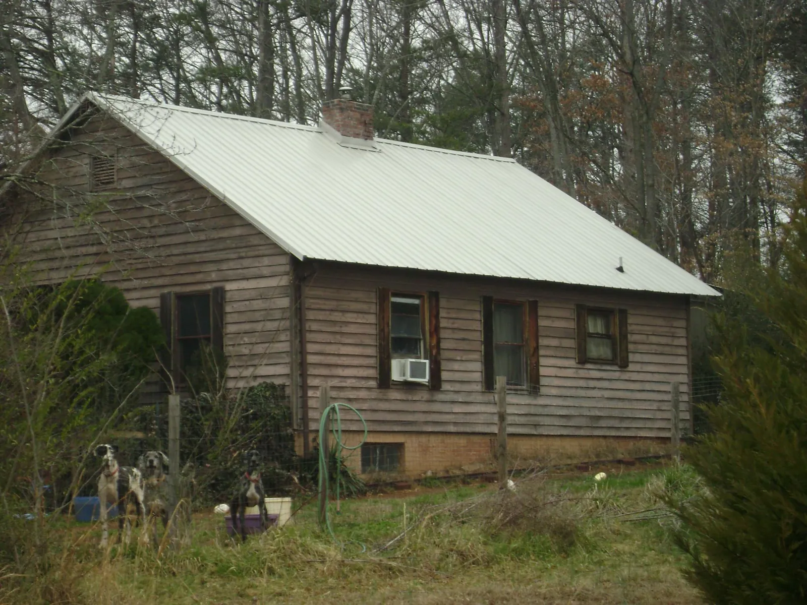 White metal roof on an old wood sided farmhouse, from a Metal Roof Installation job in Stow